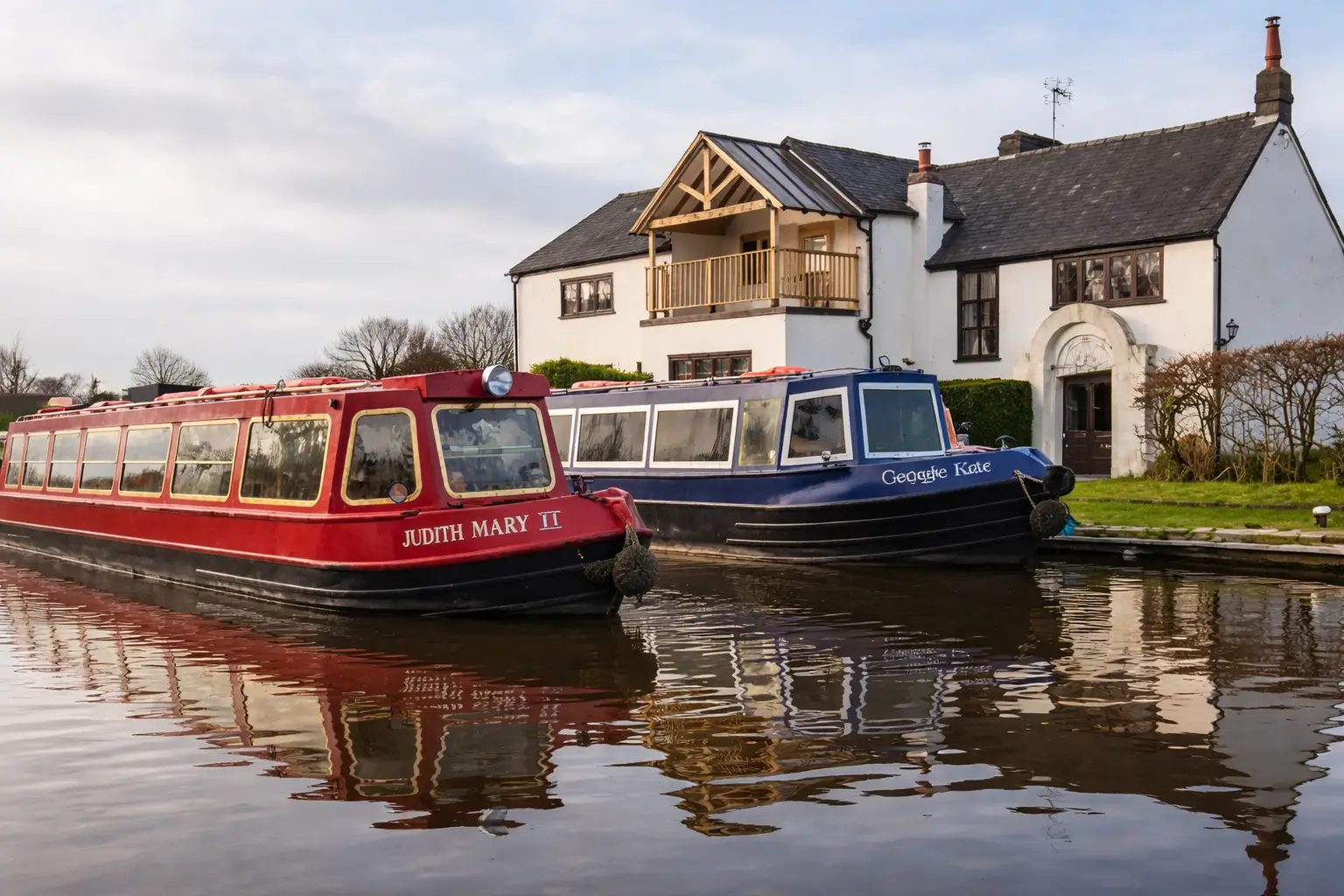 Two narrowboats moored together on a UK canal.